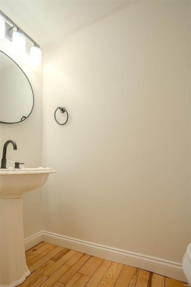 bathroom with hardwood / wood-style floors