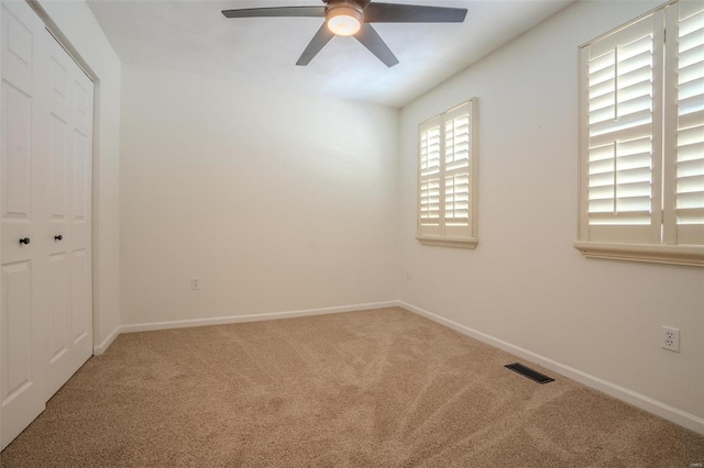 empty room with carpet flooring and ceiling fan