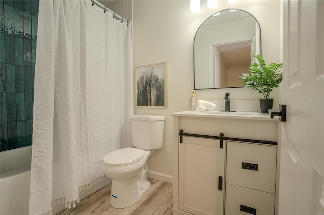 bathroom with wood-type flooring, vanity, and toilet