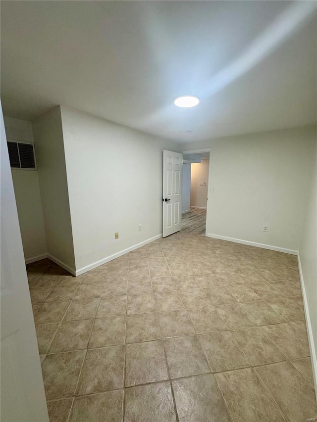 empty room with light tile patterned floors