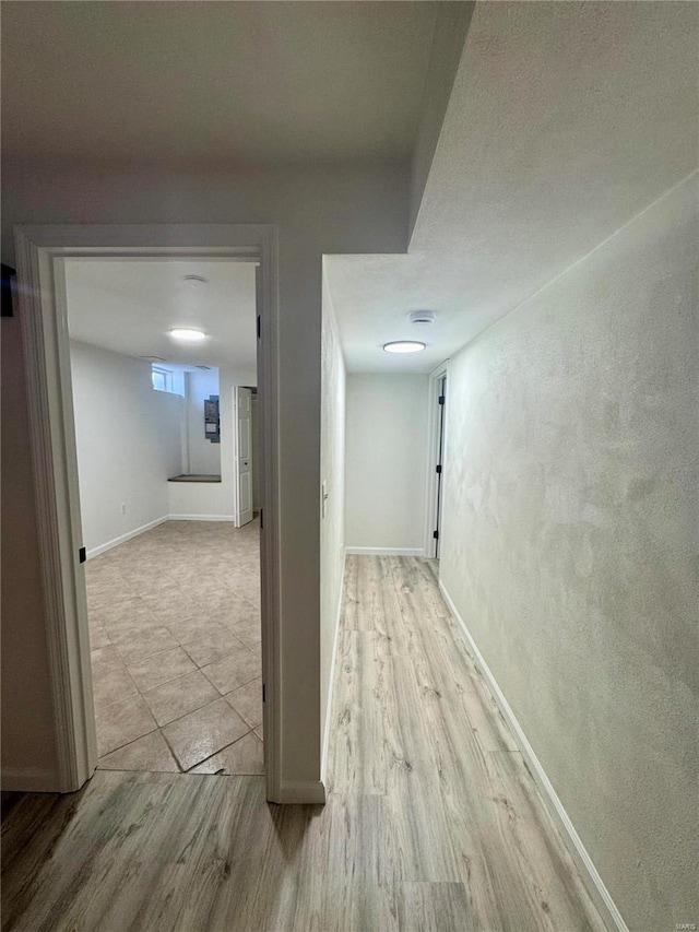 corridor with light hardwood / wood-style flooring