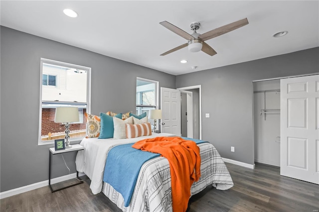 bedroom featuring dark wood-type flooring, ceiling fan, and a closet