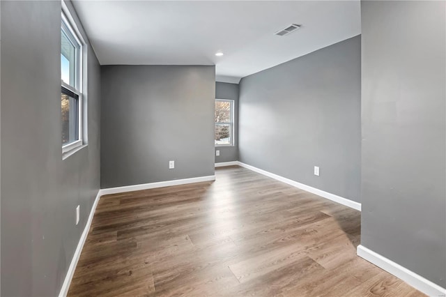 empty room with hardwood / wood-style flooring