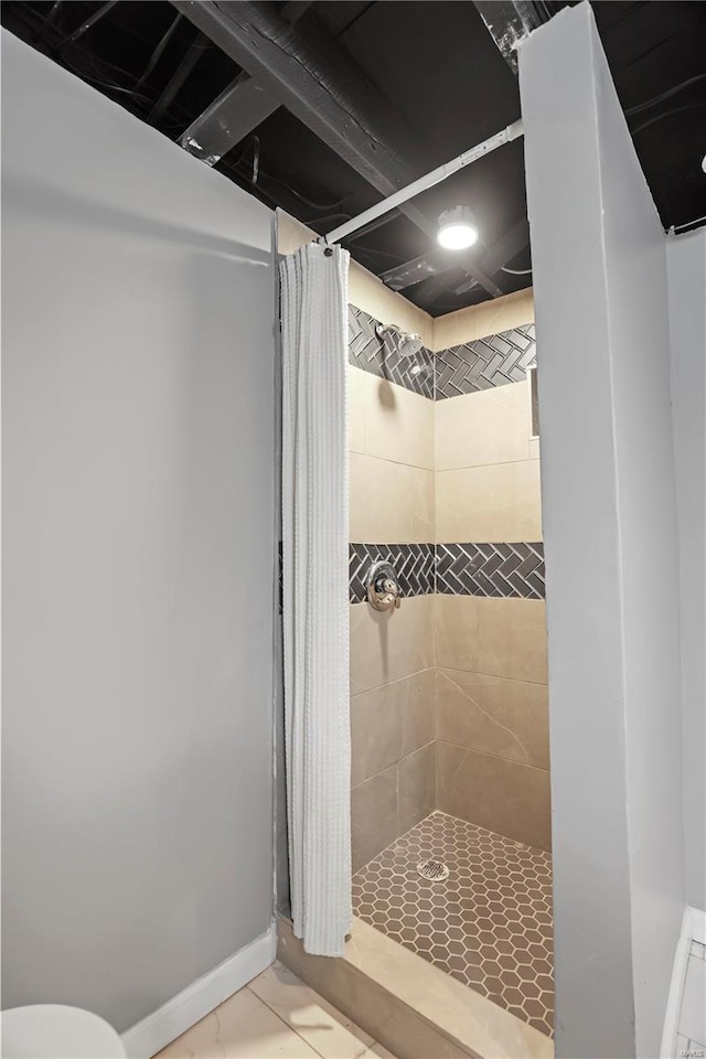 bathroom with curtained shower and tile patterned floors