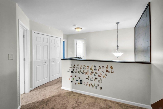 kitchen with carpet and hanging light fixtures