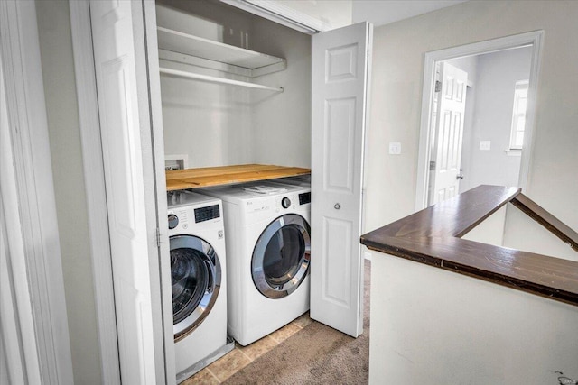 washroom featuring separate washer and dryer and laundry area