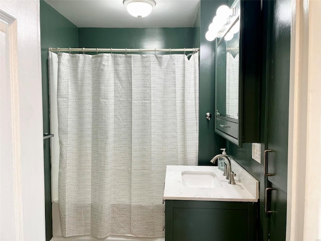 bathroom with curtained shower and vanity