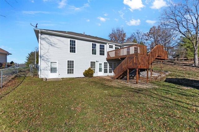 back of property with a lawn and a wooden deck