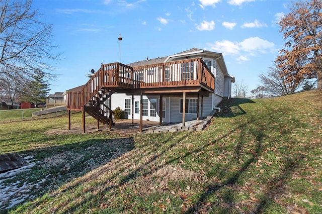 rear view of house featuring a deck and a yard