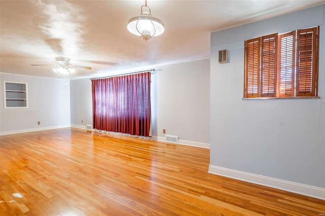 unfurnished room featuring hardwood / wood-style flooring and ceiling fan