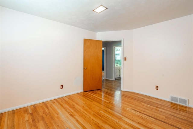 spare room featuring light wood-type flooring