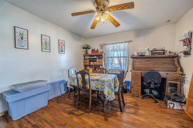 dining space featuring hardwood / wood-style floors, a textured ceiling, and ceiling fan