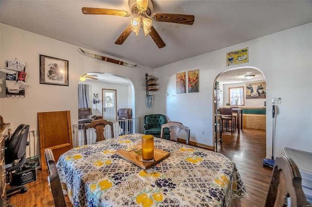 dining space featuring ceiling fan and dark hardwood / wood-style flooring