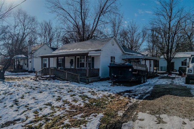 view of snowy exterior featuring a porch