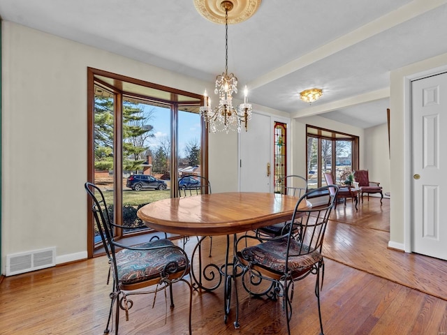 dining area featuring an inviting chandelier and light wood-type flooring