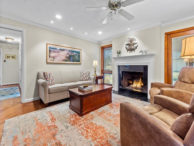 living room with ornamental molding, ceiling fan, and light hardwood / wood-style floors