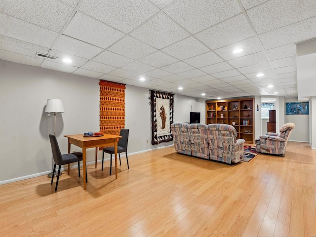 living room with hardwood / wood-style flooring and built in shelves