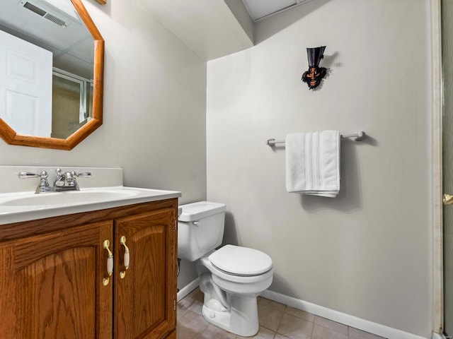 bathroom with tile patterned flooring, vanity, and toilet