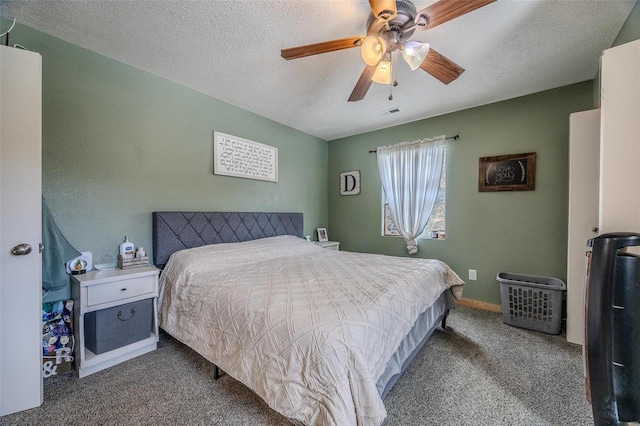 bedroom with a textured ceiling, ceiling fan, and carpet flooring