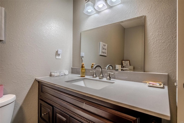 bathroom featuring toilet and vanity