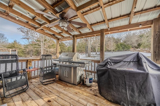 wooden deck with area for grilling and ceiling fan