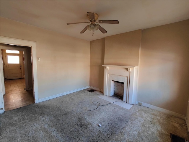 unfurnished living room featuring light carpet and ceiling fan