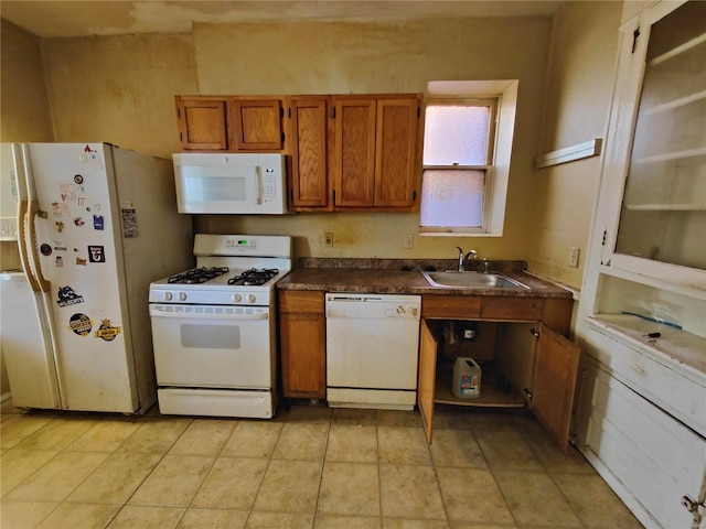 kitchen featuring white appliances and sink