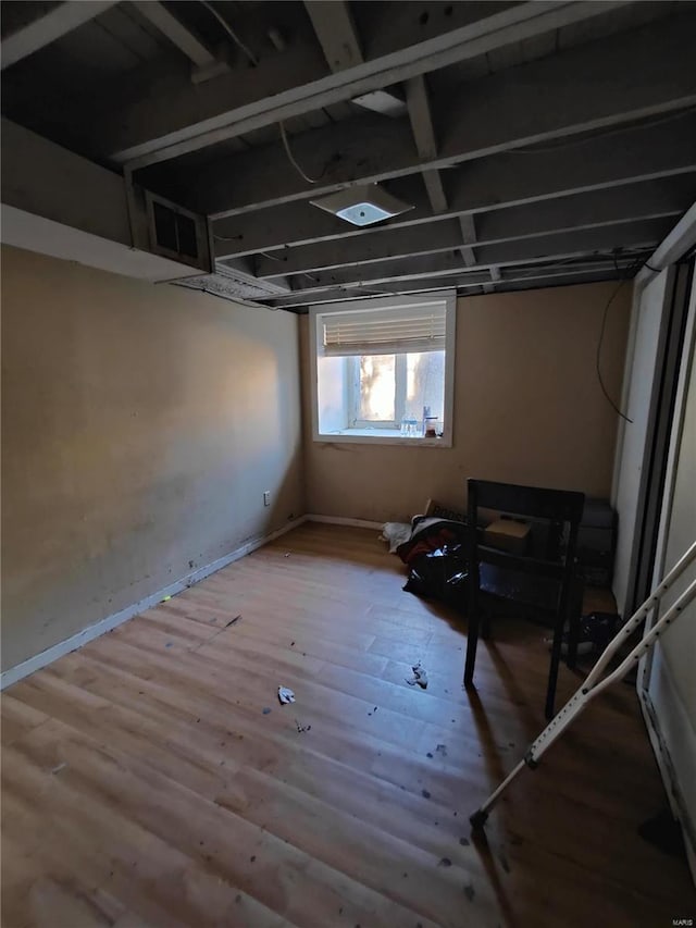 basement featuring hardwood / wood-style floors