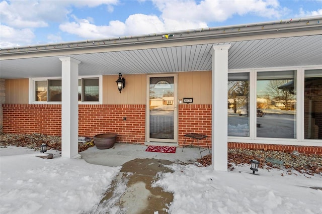 view of snow covered property entrance