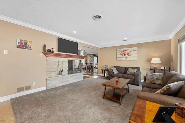 living room with crown molding, carpet, and a stone fireplace