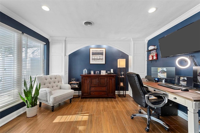 office space with ornamental molding and light hardwood / wood-style floors