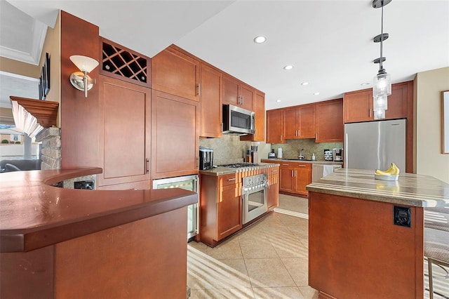 kitchen with a kitchen bar, light tile patterned floors, tasteful backsplash, pendant lighting, and appliances with stainless steel finishes