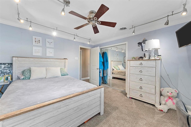 carpeted bedroom featuring a closet, ceiling fan, and ornamental molding