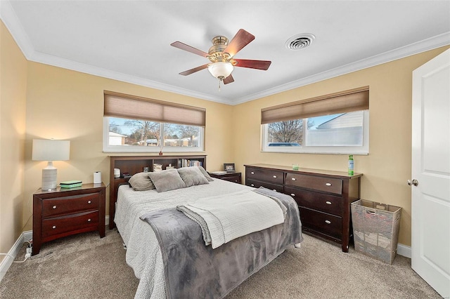 bedroom with ornamental molding, ceiling fan, light carpet, and multiple windows