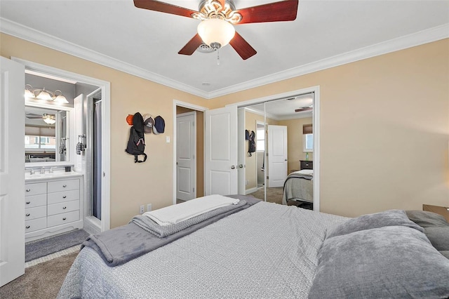 carpeted bedroom with sink, ceiling fan, ornamental molding, a closet, and ensuite bath