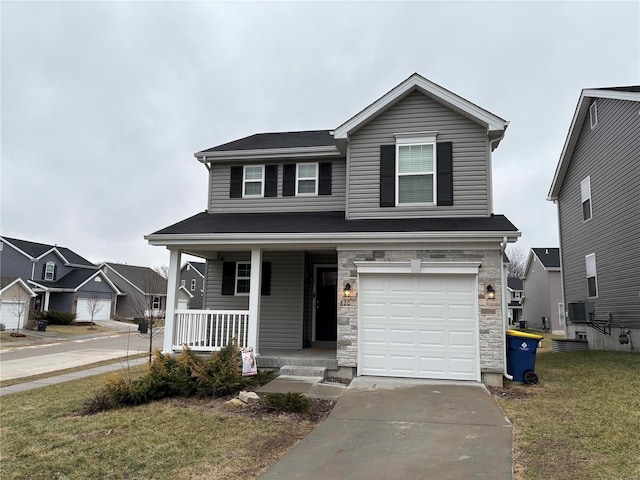 view of front of house featuring a garage, a front lawn, and a porch