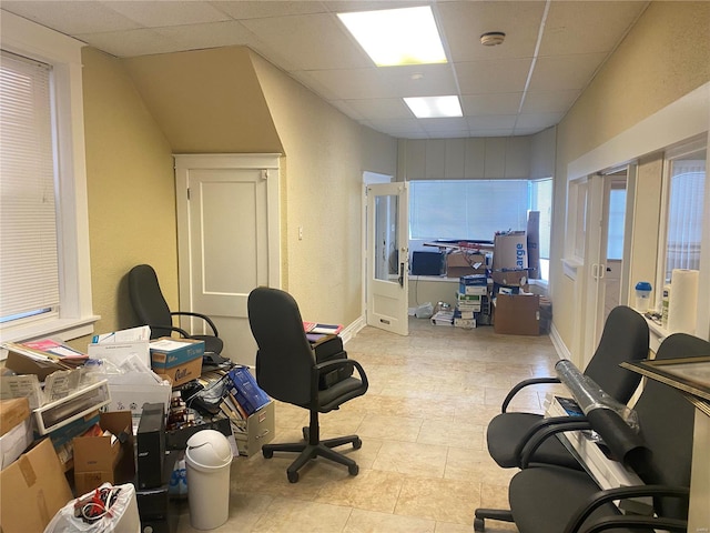 home office featuring a paneled ceiling and plenty of natural light