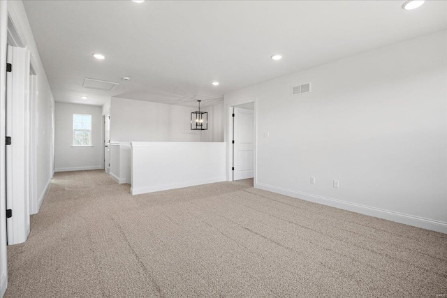 spare room featuring recessed lighting, visible vents, light colored carpet, and baseboards