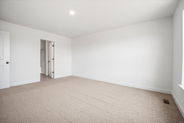 empty room with light carpet, baseboards, visible vents, and recessed lighting