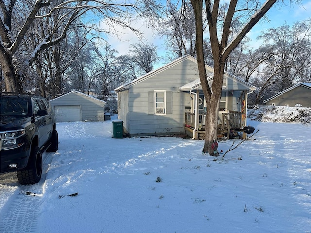 view of front of house with a garage and an outdoor structure