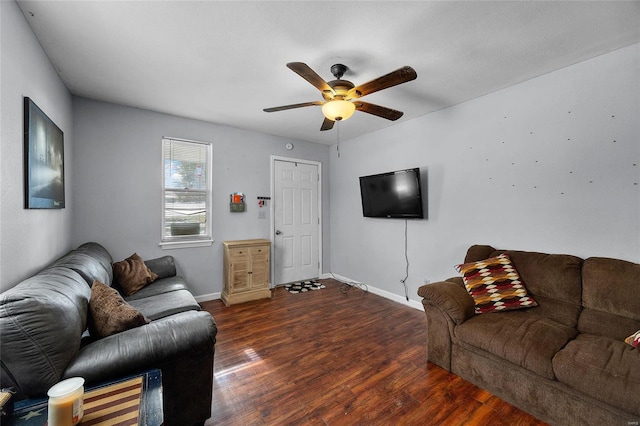 living room with ceiling fan and dark hardwood / wood-style flooring