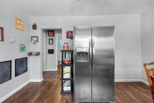 kitchen featuring dark hardwood / wood-style flooring and stainless steel fridge