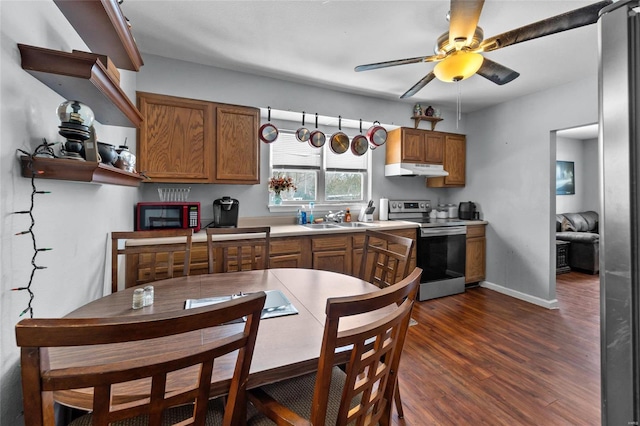 kitchen featuring ceiling fan, sink, dark hardwood / wood-style floors, and stainless steel range with electric stovetop