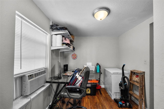 office featuring cooling unit, dark wood-type flooring, and a textured ceiling