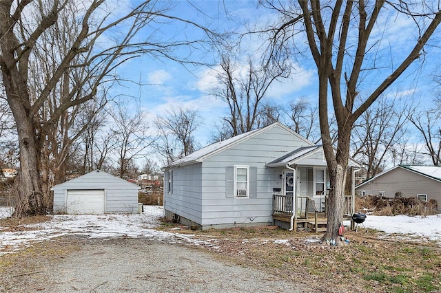 view of front of home with a garage and an outbuilding