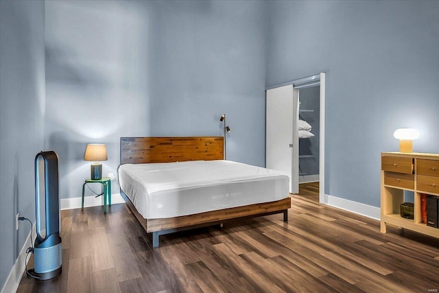 bedroom with a closet and dark wood-type flooring