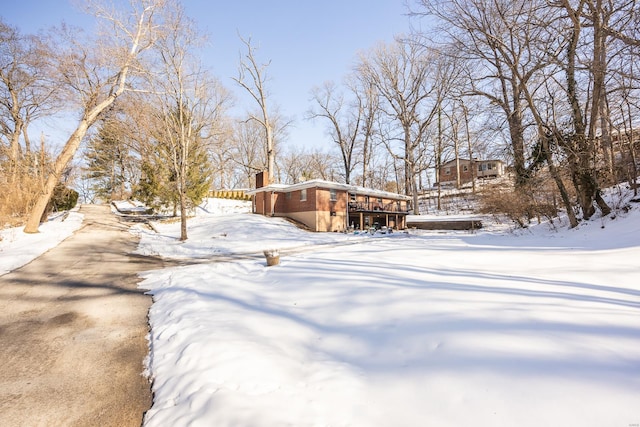 snowy yard with a wooden deck