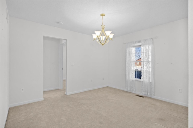 unfurnished room with light carpet and an inviting chandelier