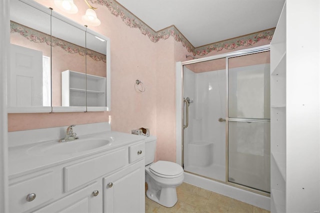 bathroom with vanity, an enclosed shower, and toilet