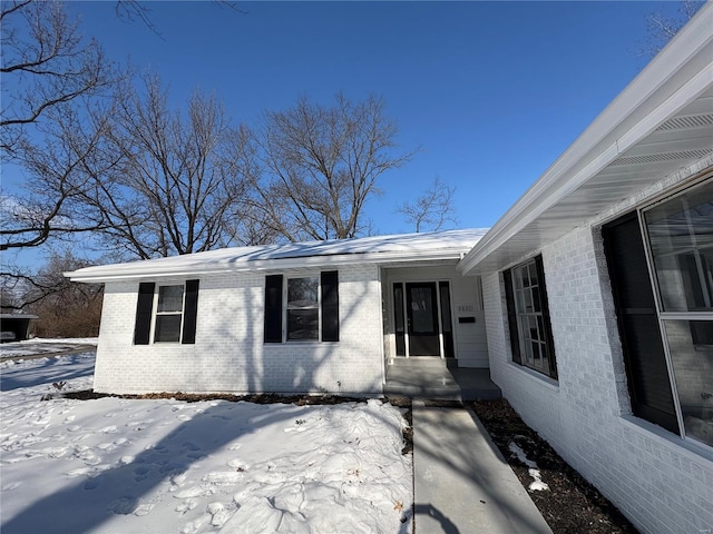 view of snow covered property entrance